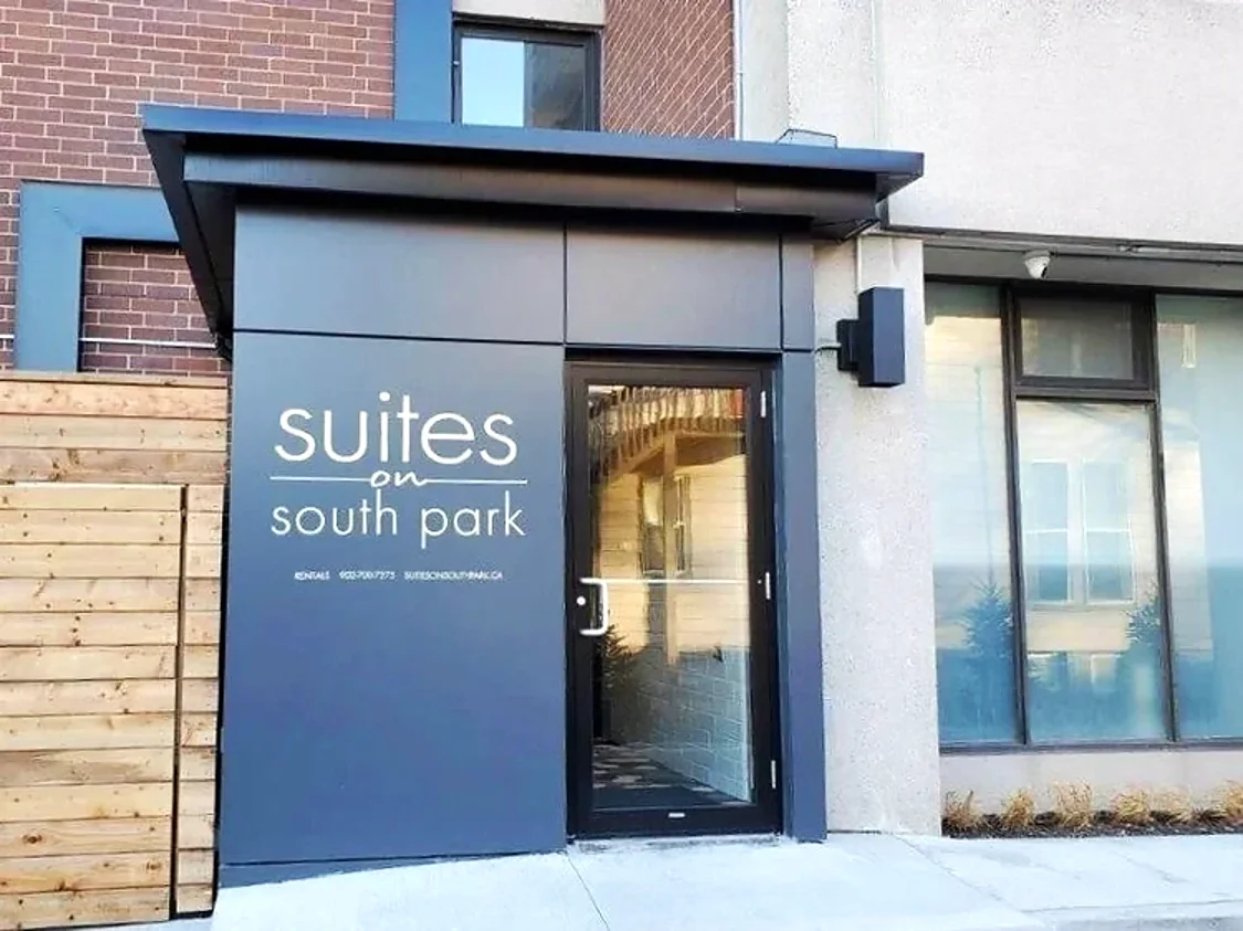 Suites on South Park entrance vestibule with white lettering on a charcoal panel